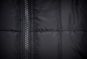 Close-up of a zipper on a black padded coat