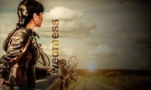 women in a leather jacket on a motorcycle looking off in the distance, the word wearness is over the image