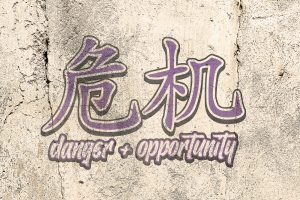 graphic image with Chinese letters and the words danger + opportunity.