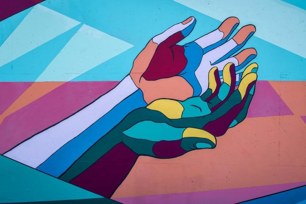 Wall art of a pair of hands in different colors