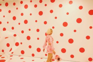A women in a room with red dots all around