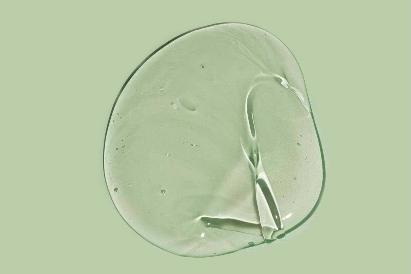 clear liquid on a green background 