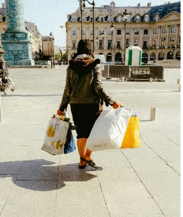 A women walking in Paris with shopping bags