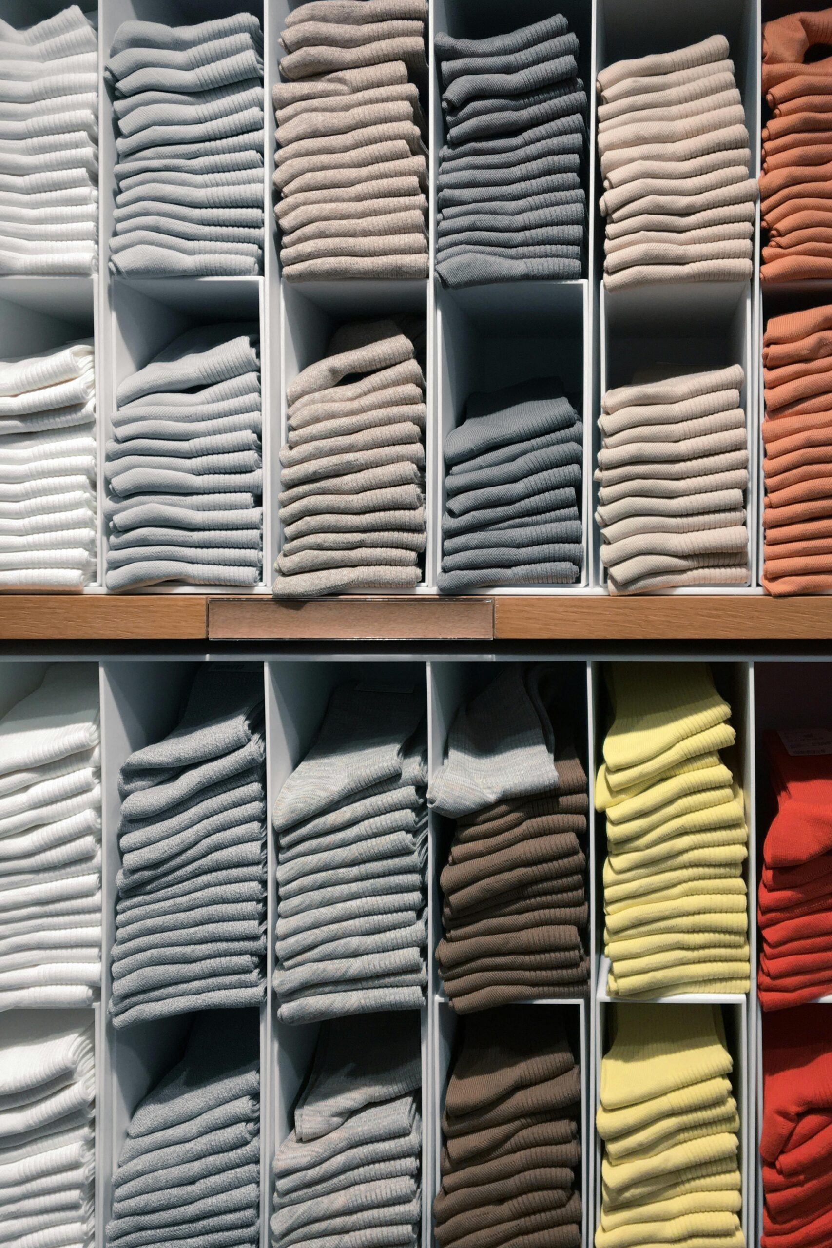 Folded shirts on a shelf in a clothing store