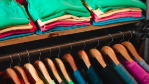 Shirts and Sweatshirts handing on a rack in a clothing store