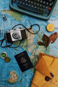 A camera and a passport over a map of the world
